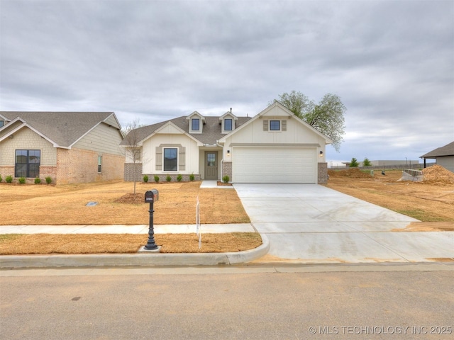 13404 E 123rd Pl, Collinsville, OK 74021 - view of front of home featuring concrete driveway, an attached garage, brick siding, and board and batten siding