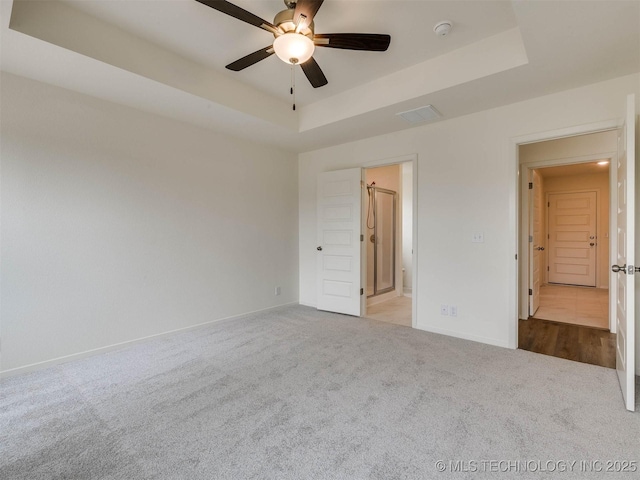 13404 E 123rd Pl, Collinsville, OK 74021 - unfurnished bedroom featuring baseboards, a ceiling fan, a tray ceiling, and carpet