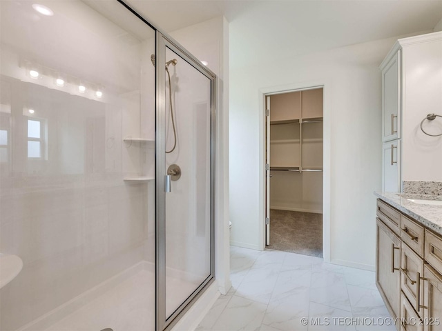 13404 E 123rd Pl, Collinsville, OK 74021 - full bathroom featuring a stall shower, a walk in closet, vanity, marble finish floor, and baseboards