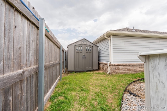 view of yard featuring an outbuilding, a storage unit, and fence