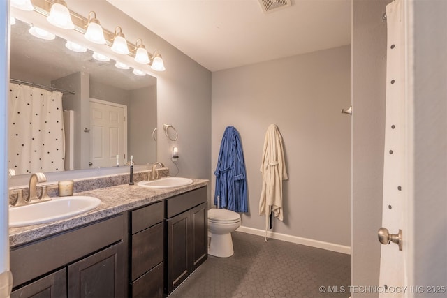 bathroom featuring tile patterned flooring, visible vents, toilet, and a sink