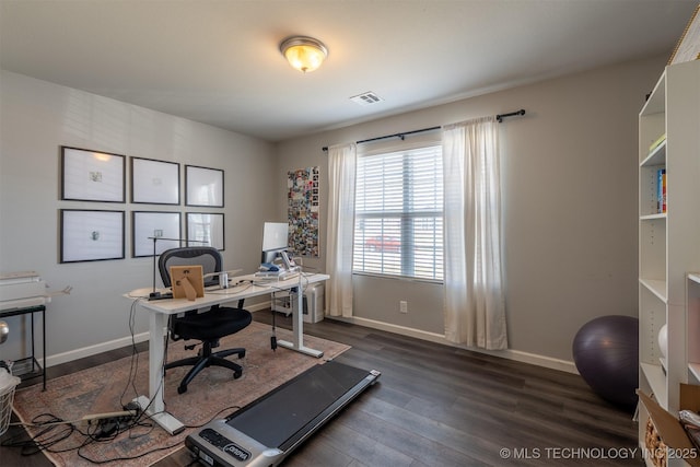 office space with visible vents, baseboards, and dark wood-style floors