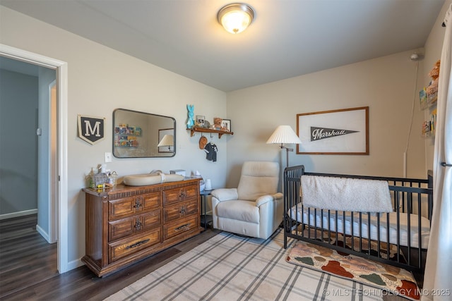 bedroom featuring baseboards and wood finished floors