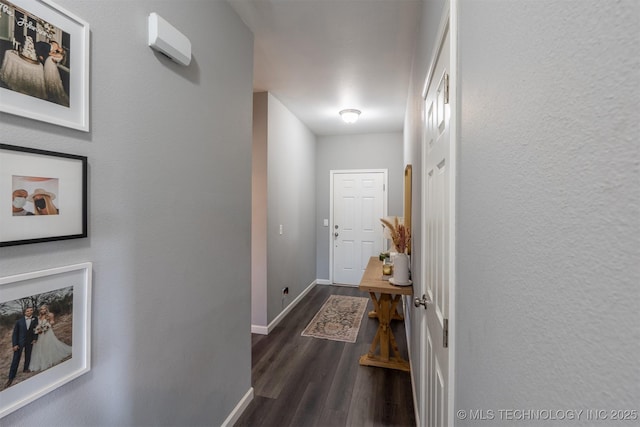 hall with dark wood finished floors and baseboards