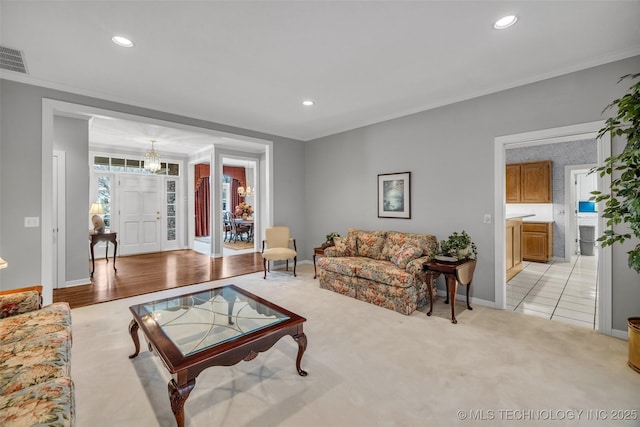 living area featuring light carpet, recessed lighting, and crown molding