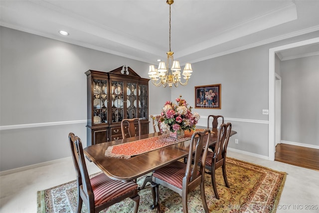 dining room with a notable chandelier, baseboards, carpet, and a tray ceiling