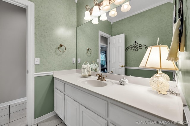 bathroom with a chandelier, vanity, crown molding, and baseboards