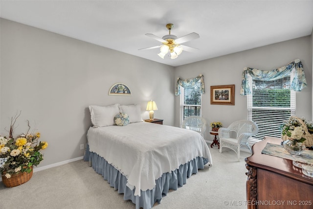 bedroom featuring light colored carpet, baseboards, and ceiling fan