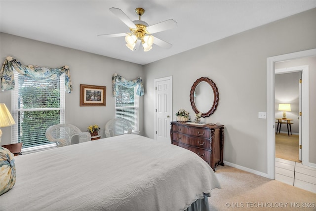 bedroom with light tile patterned floors, a ceiling fan, baseboards, a closet, and light carpet