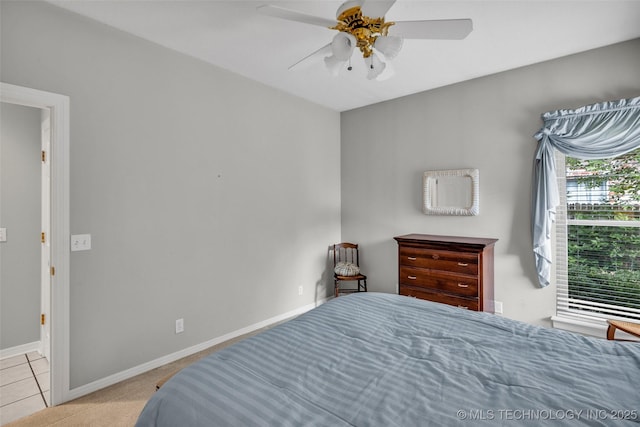 bedroom featuring baseboards and a ceiling fan