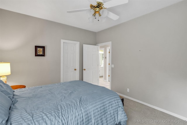 bedroom with a ceiling fan, light colored carpet, and baseboards