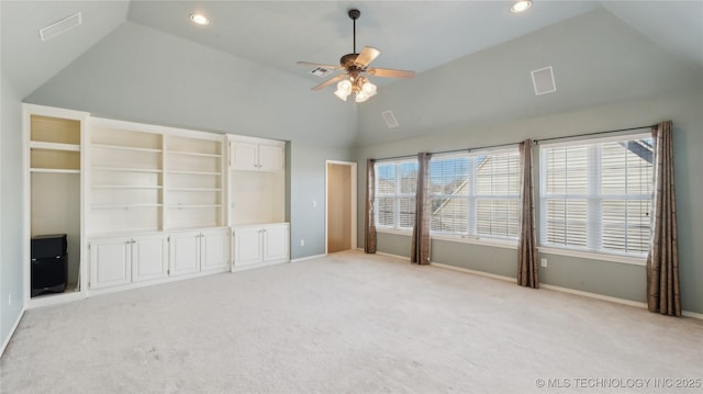 unfurnished bedroom with light colored carpet, baseboards, lofted ceiling, and multiple windows