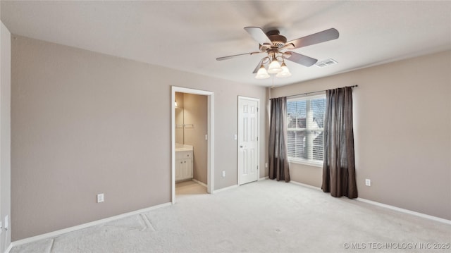 unfurnished bedroom with visible vents, baseboards, light colored carpet, a closet, and ensuite bath