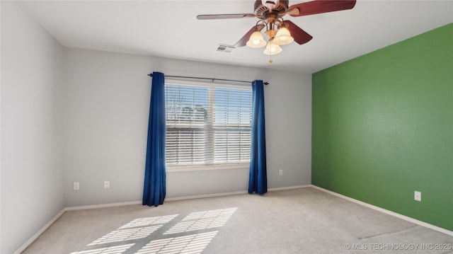 unfurnished room with visible vents, ceiling fan, baseboards, and carpet