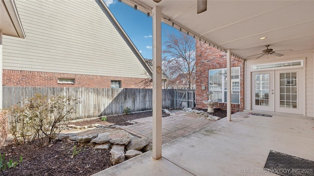 view of patio with a fenced backyard, french doors, and a ceiling fan