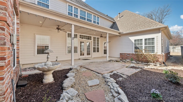 rear view of house featuring a patio, a ceiling fan, a shingled roof, french doors, and brick siding