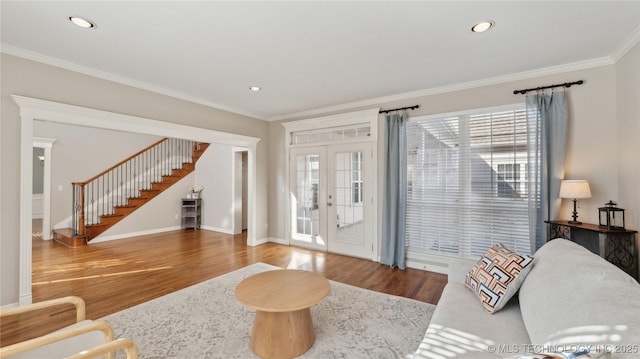 living room with stairway, wood finished floors, recessed lighting, french doors, and crown molding