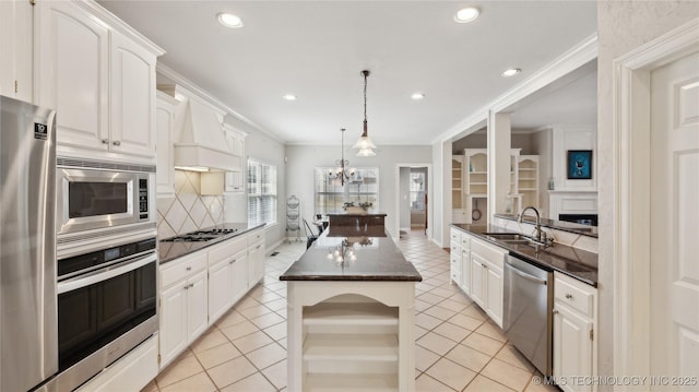 kitchen with premium range hood, appliances with stainless steel finishes, light tile patterned flooring, and a sink