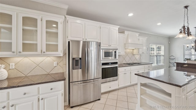 kitchen featuring glass insert cabinets, custom range hood, light tile patterned floors, appliances with stainless steel finishes, and white cabinets