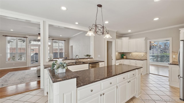 kitchen with decorative backsplash, appliances with stainless steel finishes, and a healthy amount of sunlight