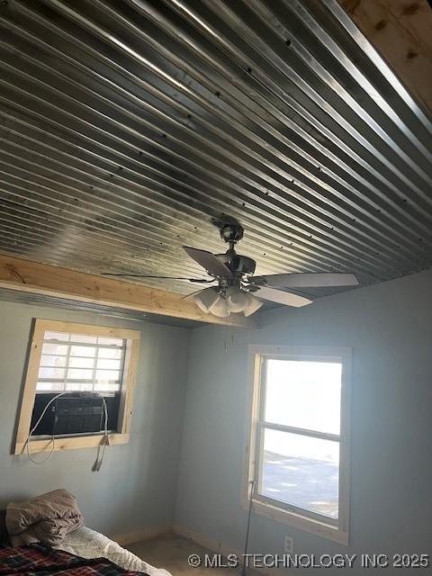 interior space featuring cooling unit and a ceiling fan
