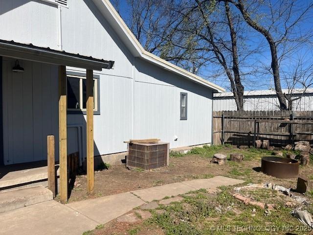 view of home's exterior featuring fence and central AC