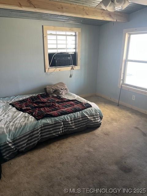 carpeted bedroom featuring a ceiling fan and baseboards
