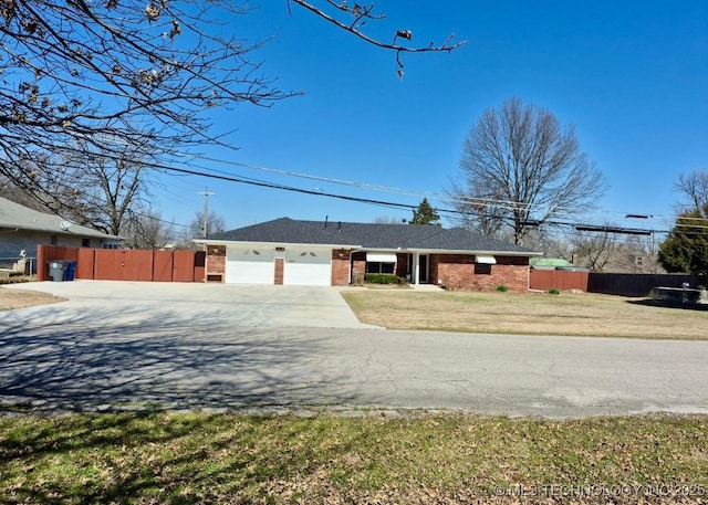 ranch-style house featuring brick siding, fence, a garage, and driveway