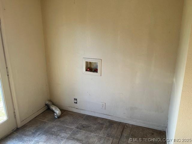 clothes washing area featuring baseboards, washer hookup, and laundry area