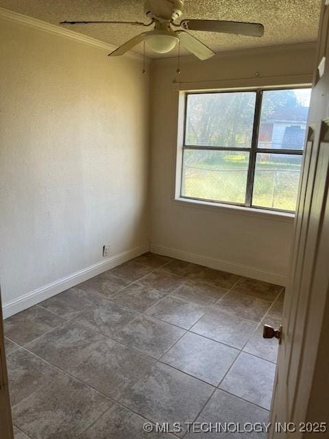 unfurnished room featuring a textured ceiling, ceiling fan, and baseboards