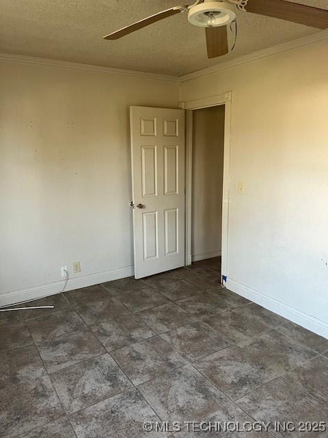 empty room featuring crown molding, baseboards, a textured ceiling, and ceiling fan