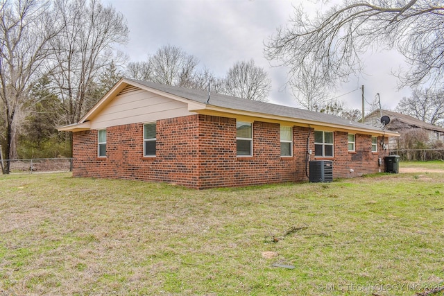 415347 E 1912th Rd, Antlers, OK 74523 - rear view of house with central AC, brick siding, fence, and a lawn
