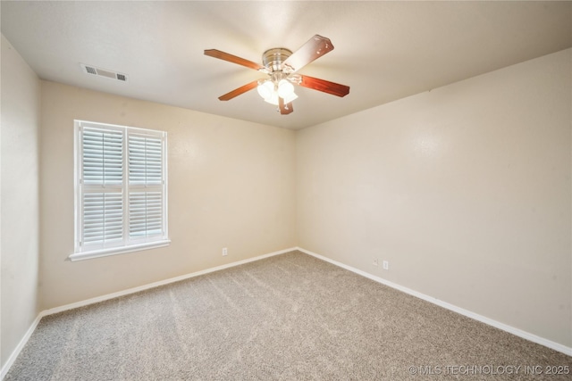 spare room with visible vents, carpet floors, baseboards, and ceiling fan