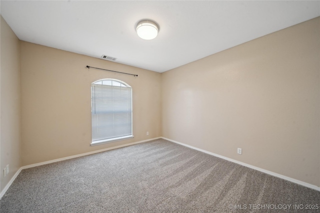 carpeted empty room with baseboards and visible vents