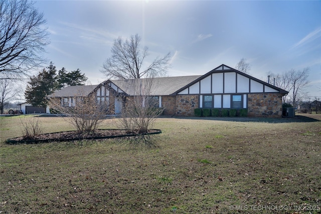 view of front facade with stone siding, central air condition unit, and a front lawn