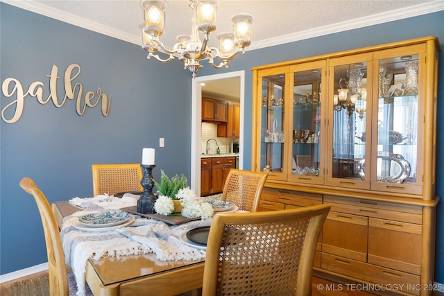 dining room with crown molding, a notable chandelier, and a textured ceiling