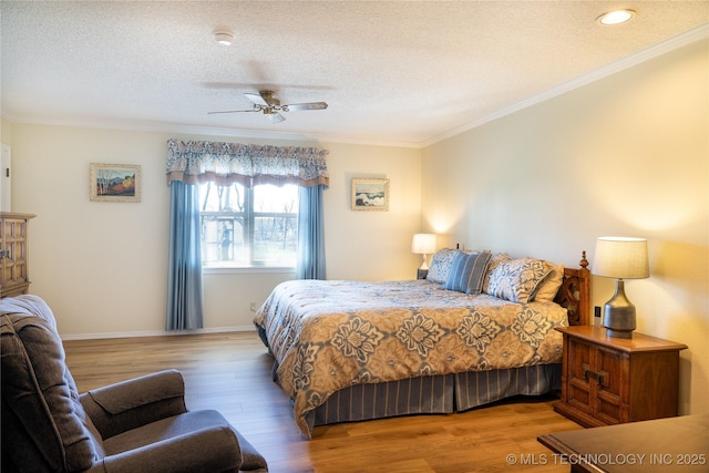 bedroom with a textured ceiling, wood finished floors, and ornamental molding