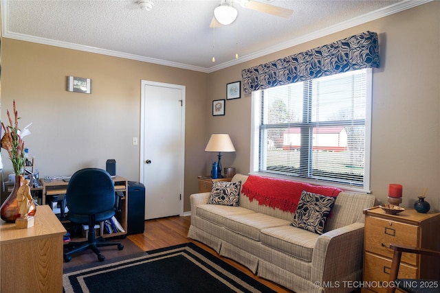 home office featuring a ceiling fan, a textured ceiling, wood finished floors, and ornamental molding