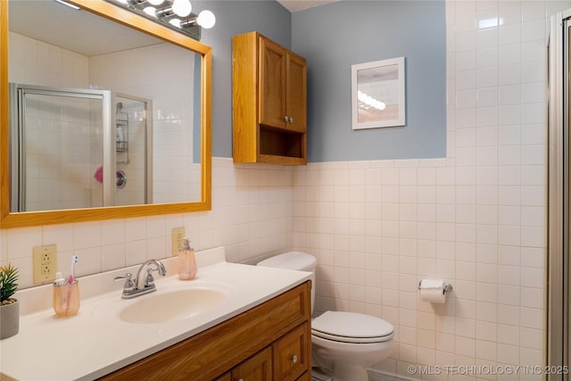 full bath featuring vanity, tile walls, toilet, and a stall shower