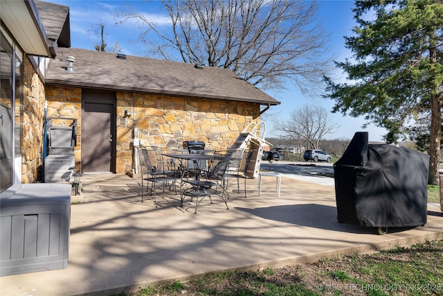 view of patio with outdoor dining area and grilling area