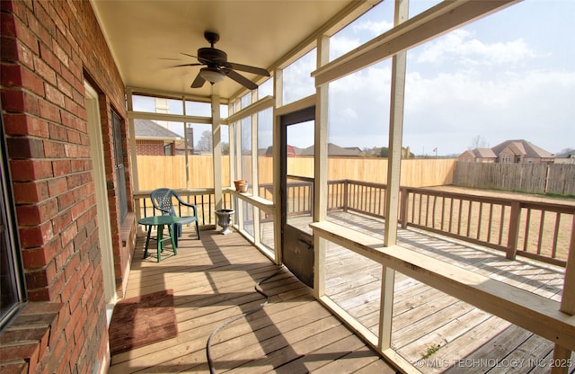 sunroom featuring ceiling fan