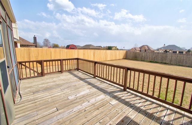 wooden terrace featuring a fenced backyard