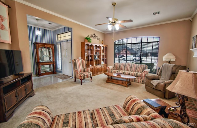 living room with visible vents, crown molding, a ceiling fan, and carpet floors