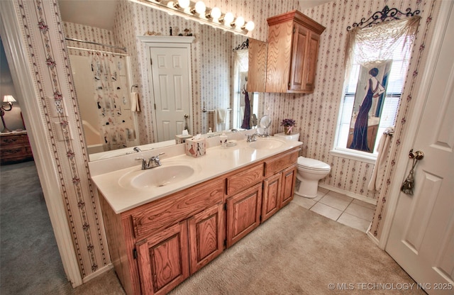 full bathroom featuring tile patterned floors, toilet, wallpapered walls, and a sink