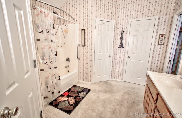 bathroom featuring vanity, wallpapered walls, and shower / bath combo with shower curtain