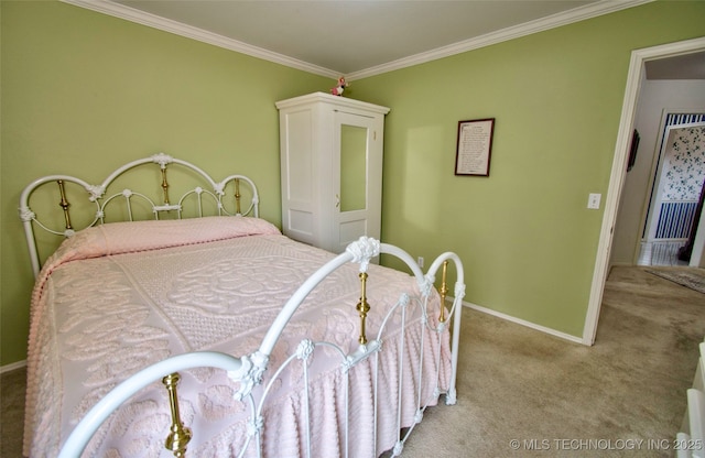 carpeted bedroom with crown molding and baseboards