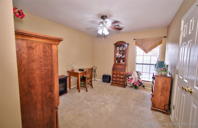 carpeted office featuring visible vents, baseboards, and a ceiling fan