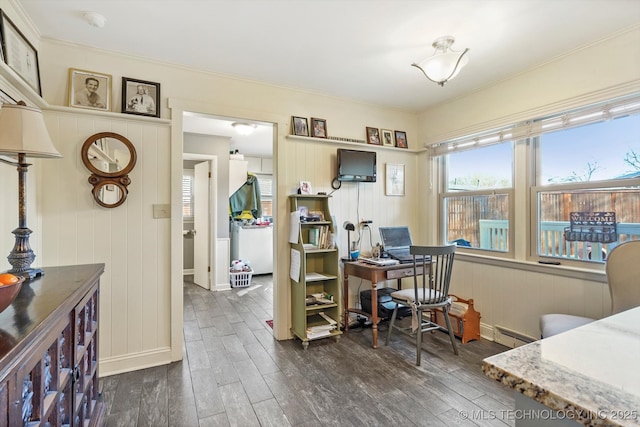 home office featuring a baseboard heating unit, dark wood finished floors, and crown molding