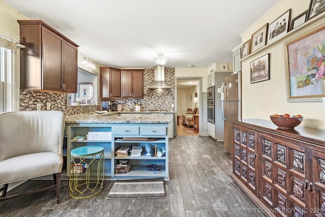 kitchen featuring dark wood-type flooring, open shelves, tasteful backsplash, appliances with stainless steel finishes, and wall chimney range hood
