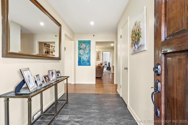 hallway with dark wood finished floors and baseboards